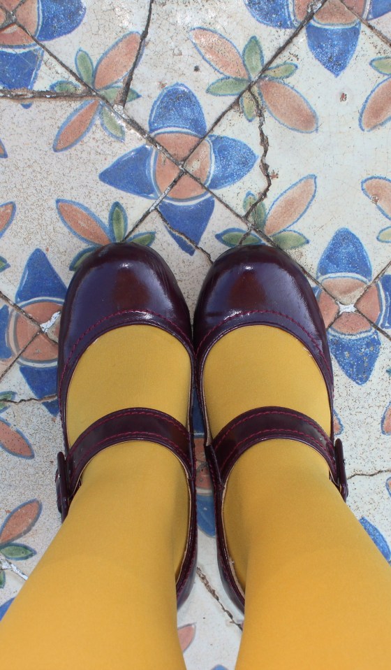 feet, yellow leggings, purple shoes, historic tiles